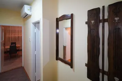 a mirror on a wall next to a hallway at City center in Zaječar