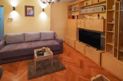 a living room with a couch and a flat screen tv at City center in Zaječar