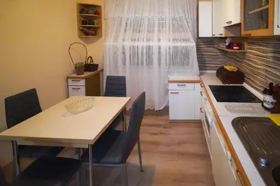 a kitchen with a table and chairs and a window at City center in Zaječar