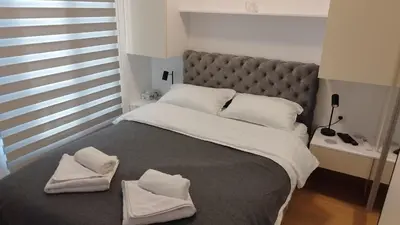 a bedroom with a large bed with towels on it at Royal Vila Bozovic - G5 i G6 in Vrnjačka Banja