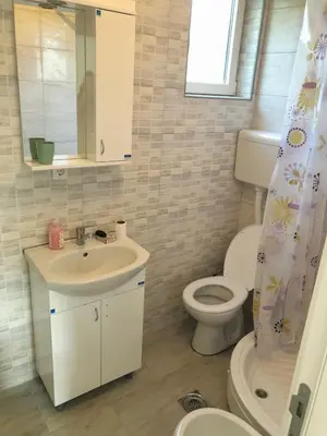 a bathroom with a sink and a toilet and a mirror at Vila Kruna in Soko Banja