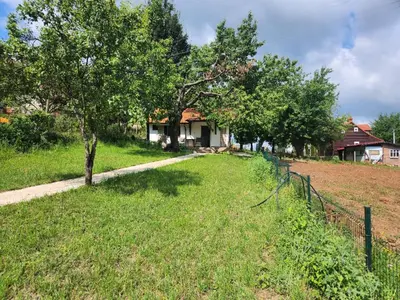 a yard with a fence and trees and a house at Vila Kruna in Soko Banja