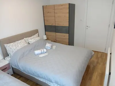 a bedroom with a bed with two cups on it at Apartman Pan in Soko Banja