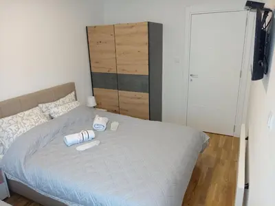 a bedroom with a bed with two cups on it at Apartman Pan in Soko Banja