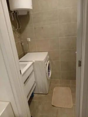 a small bathroom with a washing machine in it at Apartman Pan in Soko Banja