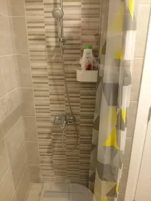 a shower with a shower curtain in a bathroom at Apartman Pan in Soko Banja