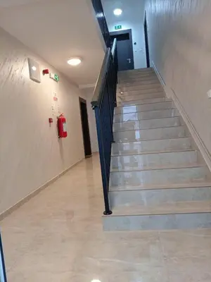 a staircase in a building with a red fire hydrant at Apartman Pan in Soko Banja