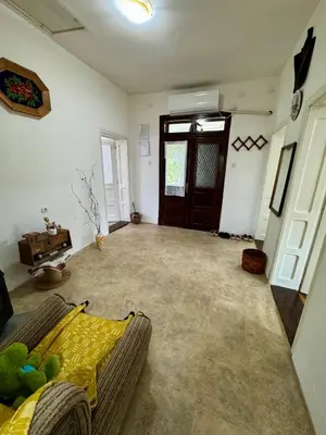 an empty living room with a couch and a door at Idila pod Rtnjem - Najam cele vikendice sa bazenom in Ilino