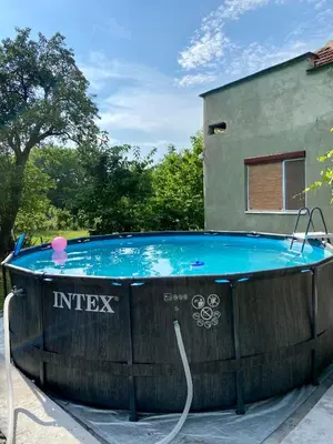 a hot tub in a yard next to a building at Idila pod Rtnjem - Najam cele vikendice sa bazenom in Ilino