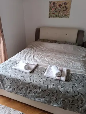 a bed with two towels sitting on top of it at DREAMER apartment in Vrnjačka Banja