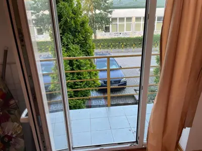 a window with a view of a car on a street at DREAMER apartment in Vrnjačka Banja