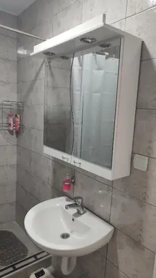 a bathroom with a white sink and a mirror at Black and White in Pirot