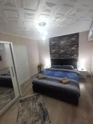 a bedroom with a bed and a stone wall at DJERDAN in Vranje