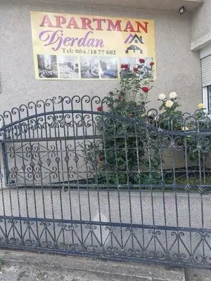 a wrought iron fence with flowers in a planter at DJERDAN in Vranje