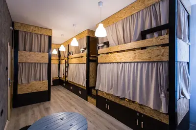 a large room with bunk beds with curtains at Hostel Day 'N' Night in Niš
