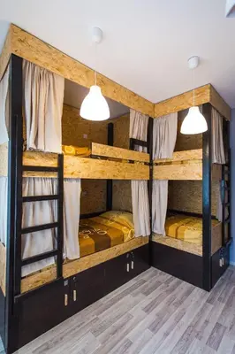 two bunk beds in a room with wooden floors at Hostel Day 'N' Night in Niš
