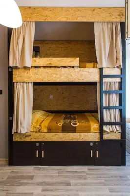 two bunk beds in a room with a yellow bed at Hostel Day 'N' Night in Niš