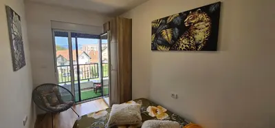 a living room with a picture of a leopard on the wall at Vrnjački Lux free parking GARAGE in Vrnjačka Banja