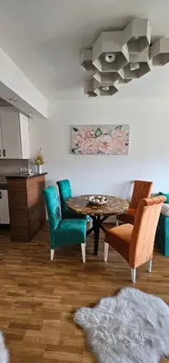a living room with a table and chairs at Vrnjački Lux free parking GARAGE in Vrnjačka Banja