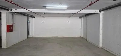 an empty garage with a white wall at Vrnjački Lux free parking GARAGE in Vrnjačka Banja