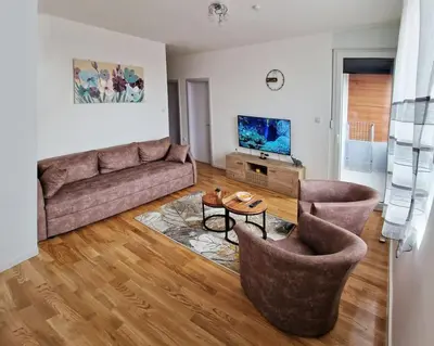 a living room with a couch and two chairs at Sunflower apartment in Niš