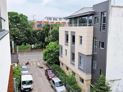 a parking lot with cars parked next to a building at Sunflower apartment in Niš
