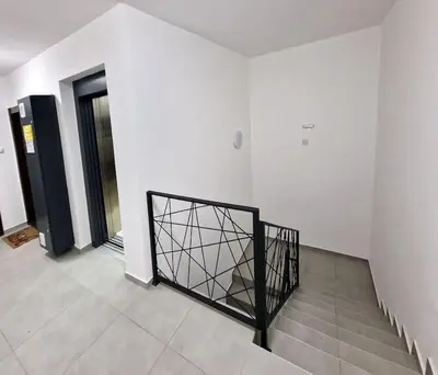 a staircase with a black gate in a building at Sunflower apartment in Niš