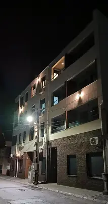 a building with a street light in front of it at night at Sunflower apartment in Niš