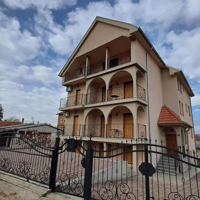 a building with a fence in front of it at Apartmani Talija 3 i 4 Sokobanja in Soko Banja