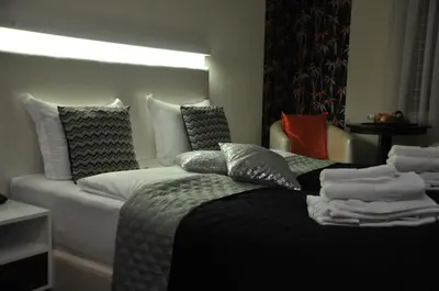 a hotel room with a bed with pillows on it at Apartments Biser in Vrnjačka Banja