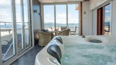 a jacuzzi tub in a room with a balcony at Apartments Biser in Vrnjačka Banja