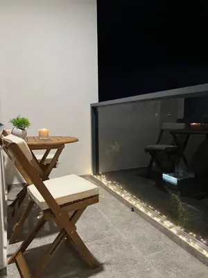a table and a chair next to a fish tank at MM LUX apartment in Niš