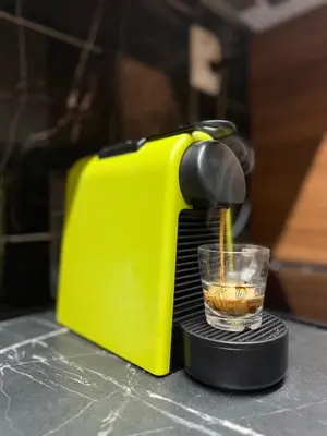 a yellow toaster sitting on a counter with a glass at MM LUX apartment in Niš