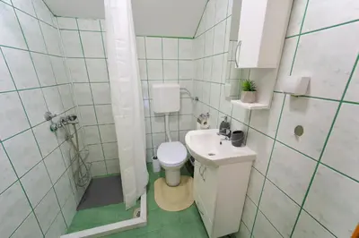 a small bathroom with a toilet and a sink at Studio Petra in Soko Banja