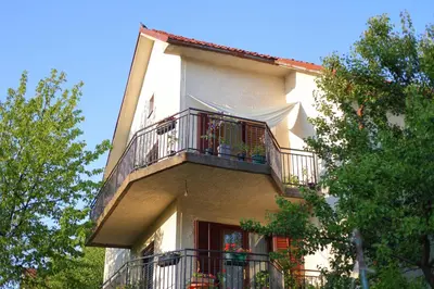 a building with a balcony with plants on it at Studio Petra in Soko Banja