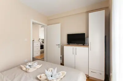a bedroom with a bed with towels on it at Duma Apartmani 1 Vrnjačka Banja in Vrnjačka Banja