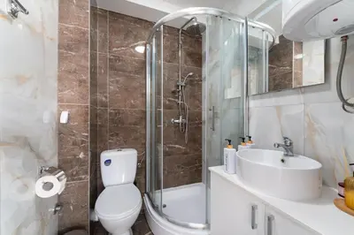 a bathroom with a toilet and a shower and a sink at Duma Apartmani 1 Vrnjačka Banja in Vrnjačka Banja