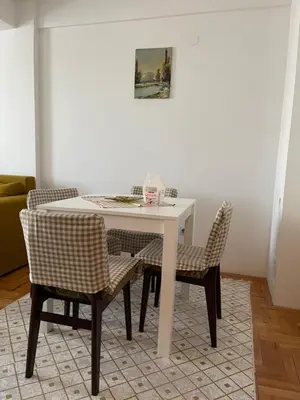 a white table and chairs in a living room at Sedmi Juli in Niš