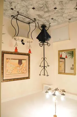 a room with a ceiling with a chandelier at Royal Apartments in Niš