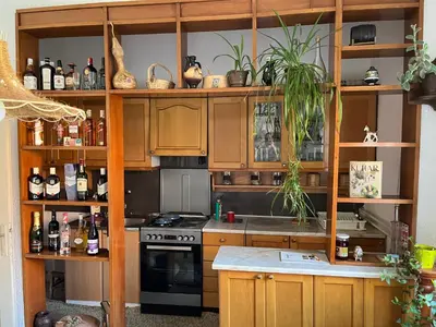 a kitchen with wooden cabinets and a stove top oven at Kobran in Kuršumlija