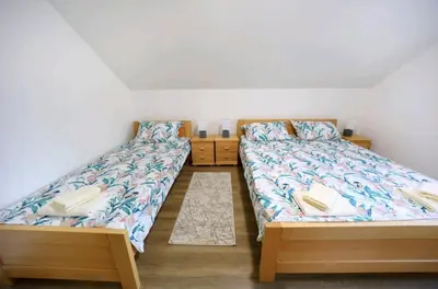 two twin beds in a room with at Apartman Luki in Soko Banja