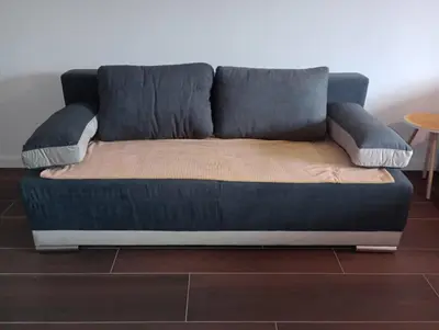 a blue couch sitting on top of a floor at AN Jezero-Apartman Jaki 12 in Vrnjačka Banja
