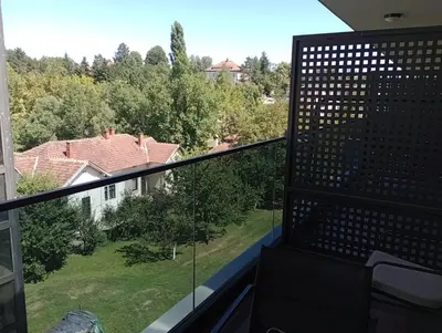 a balcony with a view of a house at AN Jezero-Apartman Jaki 12 in Vrnjačka Banja