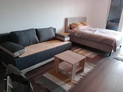 a living room with a couch and a coffee table at AN Jezero-Apartman Jaki 12 in Vrnjačka Banja
