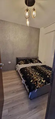 a bedroom with a bed with a black comforter at Aqua Park Lux Jagodina in Trnava