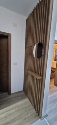 a room with a wooden door with a mirror on it at Aqua Park Lux Jagodina in Trnava