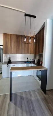 a kitchen with a large wooden table in a room at Aqua Park Lux Jagodina in Trnava