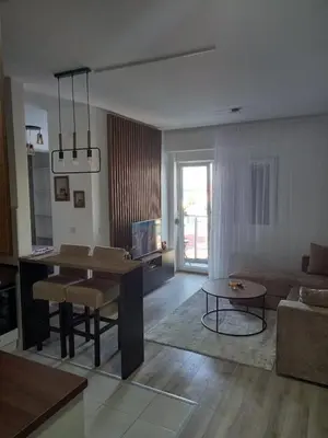 a living room with a table and a dining room at Aqua Park Lux Jagodina in Trnava