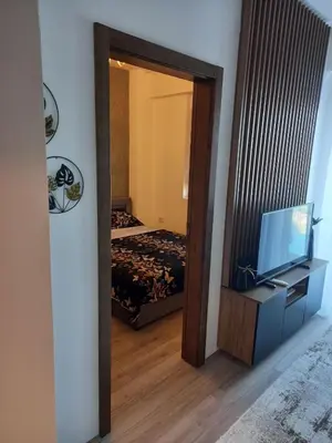 a room with a mirror and a bed and a television at Aqua Park Lux Jagodina in Trnava