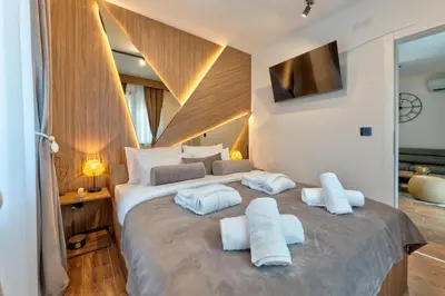 a bedroom with a large bed with white pillows at Apartman Riva in Vrnjačka Banja